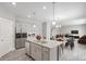 Open-concept kitchen boasts a large island with granite countertops and stainless steel appliances at 13465 Valentia Pl, Thornton, CO 80602