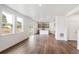Spacious living room features wood floors, modern open concept kitchen and large windows at 13465 Valentia Pl, Thornton, CO 80602