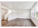 Open living room featuring wood floors, many windows and access to the stairs at 13465 Valentia Pl, Thornton, CO 80602