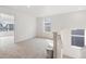 Cozy loft space with neutral carpet and natural light from windows, adjacent to stairway at 13465 Valentia Pl, Thornton, CO 80602