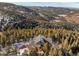 Aerial view of house nestled in a mountain setting at 13326 Kuehster Rd, Littleton, CO 80127
