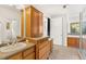 Bathroom featuring double sinks, vanity, shower, and natural light at 13326 Kuehster Rd, Littleton, CO 80127