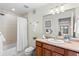 Clean bathroom with a shower/tub combo and wood vanity at 13326 Kuehster Rd, Littleton, CO 80127