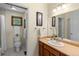 A compact full bathroom with a single sink vanity, mirror, overhead lighting, and shower/tub combination at 13326 Kuehster Rd, Littleton, CO 80127