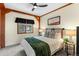 Comfortable bedroom with structural wood beams and a window view at 13326 Kuehster Rd, Littleton, CO 80127