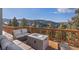 Outdoor deck showcases seating and a mountain vista for relaxing and entertaining at 13326 Kuehster Rd, Littleton, CO 80127