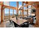 Dining room with breathtaking views, wooden beams, and a large wood table at 13326 Kuehster Rd, Littleton, CO 80127