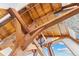 High ceilings with exposed wooden beams and large windows offering scenic views at 13326 Kuehster Rd, Littleton, CO 80127