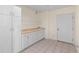 Bright laundry room with built-in cabinets and shelving at 13326 Kuehster Rd, Littleton, CO 80127