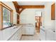 Functional laundry room with ample counter space, built-in cabinets, and a utility sink at 13326 Kuehster Rd, Littleton, CO 80127