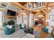 Inviting living room showcasing a stone fireplace, wood beams, and comfortable seating arrangements at 13326 Kuehster Rd, Littleton, CO 80127