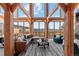 Bright living room featuring exposed beams, mountain views, and a striped rug at 13326 Kuehster Rd, Littleton, CO 80127