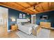 Bright main bedroom with wood ceiling, ensuite bath, and stylish decor at 13326 Kuehster Rd, Littleton, CO 80127