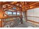 Open upper hall with wood beams and mountain views at 13326 Kuehster Rd, Littleton, CO 80127