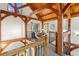Open upper hall with wood beams and curved railing at 13326 Kuehster Rd, Littleton, CO 80127