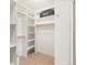 Organized walk-in closet providing plentiful storage space with shelving and wooden rods at 13326 Kuehster Rd, Littleton, CO 80127