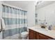 Cozy bathroom featuring a vanity, toilet, and a shower with blue and white stripped shower curtain at 7840 Ogden Ct, Denver, CO 80229