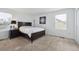 Comfortable bedroom with neutral carpet, bright light from the window and dark wooden furniture at 7840 Ogden Ct, Denver, CO 80229