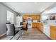 Bright kitchen with wood cabinets, white appliances, and a dining area at 7840 Ogden Ct, Denver, CO 80229