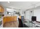 Well-lit kitchen with stainless sink, wooden cabinetry, and open access to other rooms at 7840 Ogden Ct, Denver, CO 80229