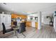 Bright eat-in kitchen with wood cabinets, white appliances, and open layout at 7840 Ogden Ct, Denver, CO 80229