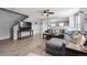Open living room boasts modern gray walls, neutral floors, and a plush sectional at 7840 Ogden Ct, Denver, CO 80229