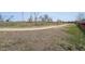 Paved pathway near a grassy field with mature trees, offering a serene environment at 7840 Ogden Ct, Denver, CO 80229
