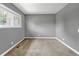 Bedroom with neutral walls, plush carpet, and window overlooking the backyard at 3354 S Flower St # 52, Lakewood, CO 80227