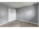 Bedroom with neutral walls, carpet, closet with sliding doors, and views outside at 3354 S Flower St # 52, Lakewood, CO 80227