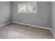 Bedroom with neutral walls, carpet, and window with views of the neighborhood at 3354 S Flower St # 52, Lakewood, CO 80227