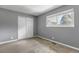 Cozy bedroom featuring neutral walls, carpet, and closet with sliding doors at 3354 S Flower St # 52, Lakewood, CO 80227