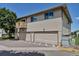 Two-story apartment building featuring neutral siding, private balcony, and individual garages for residents at 3354 S Flower St # 52, Lakewood, CO 80227