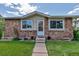 Close up of the exterior showcases a stone facade with a well-manicured lawn and walkway leading to the front door at 3354 S Flower St # 52, Lakewood, CO 80227