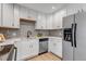 Modern kitchen with stainless steel appliances, and sleek white cabinetry at 3354 S Flower St # 52, Lakewood, CO 80227
