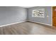 Open living room with wood flooring, large window, and light gray colored walls at 3354 S Flower St # 52, Lakewood, CO 80227