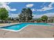 Community pool offers a refreshing retreat, surrounded by mature trees and comfortable seating for relaxation at 3354 S Flower St # 52, Lakewood, CO 80227