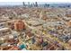 An aerial view of a city neighborhood with a vibrant skyline featuring a close-up view of the home marked with an arrow at 3424 N Marion St, Denver, CO 80205