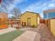 Backyard with yellow house and patio at 3424 N Marion St, Denver, CO 80205