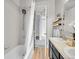 Bathroom featuring a soaking tub, updated fixtures, and a stylish vanity at 3424 N Marion St, Denver, CO 80205
