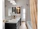 Bathroom featuring double sinks, modern fixtures, and a bathtub with a shower at 3424 N Marion St, Denver, CO 80205