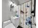 Charming bathroom with a floral shower curtain, a modern vanity, and ample lighting at 3424 N Marion St, Denver, CO 80205