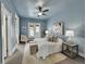 Serene bedroom with blue walls, a plush rug, and a comfortable seating area by the window at 3424 N Marion St, Denver, CO 80205