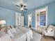 Blue bedroom with a large bed, a walk-in closet, and an ensuite bathroom at 3424 N Marion St, Denver, CO 80205