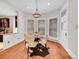 Charming dining room with wood floors, modern chandelier, and natural light from large windows at 3424 N Marion St, Denver, CO 80205