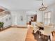 Dining room featuring hardwood floors, a modern light fixture, and staircase at 3424 N Marion St, Denver, CO 80205
