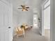 Hallway with neutral carpeting, white railings, accent chairs, and natural light streaming in at 3424 N Marion St, Denver, CO 80205