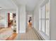 Bright hallway showcasing wood and tile flooring, leading to the staircase and living areas at 3424 N Marion St, Denver, CO 80205