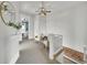Bright hallway featuring neutral carpeting, a decorative white lattice railing, and stylish armchairs at 3424 N Marion St, Denver, CO 80205