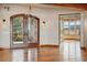 Elegant entrance showcasing wooden doors, a chandelier, and polished hardwood floors, creating a welcoming ambiance at 15175 W Belleview Ave, Morrison, CO 80465