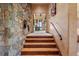 Entryway with stone wall, hardwood stairs, and views into the home at 15175 W Belleview Ave, Morrison, CO 80465